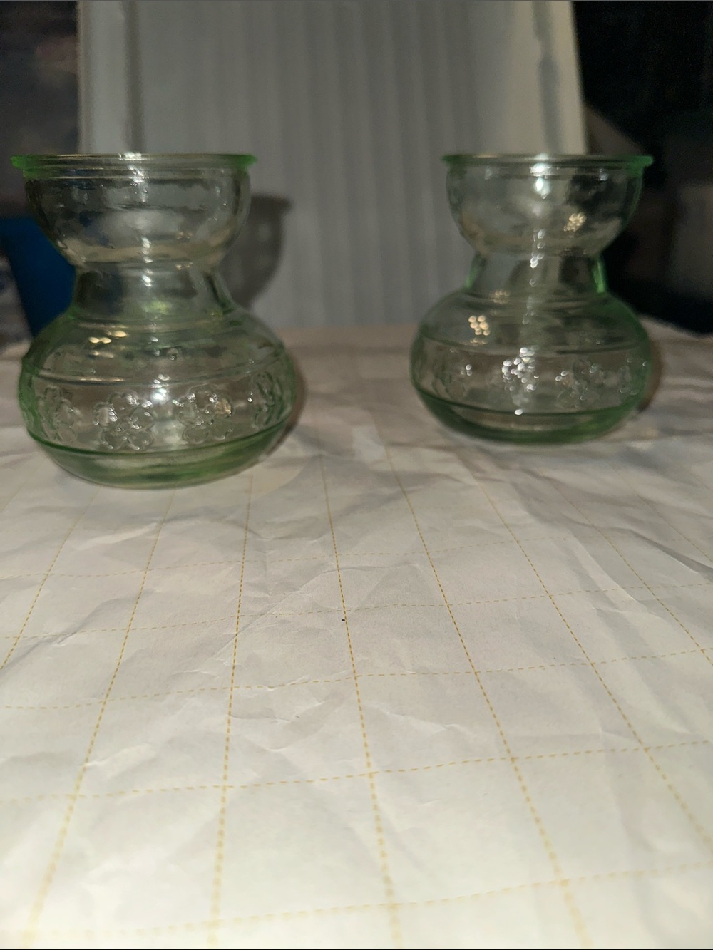 Two vintage green glass forcing vases with embossed flower designs